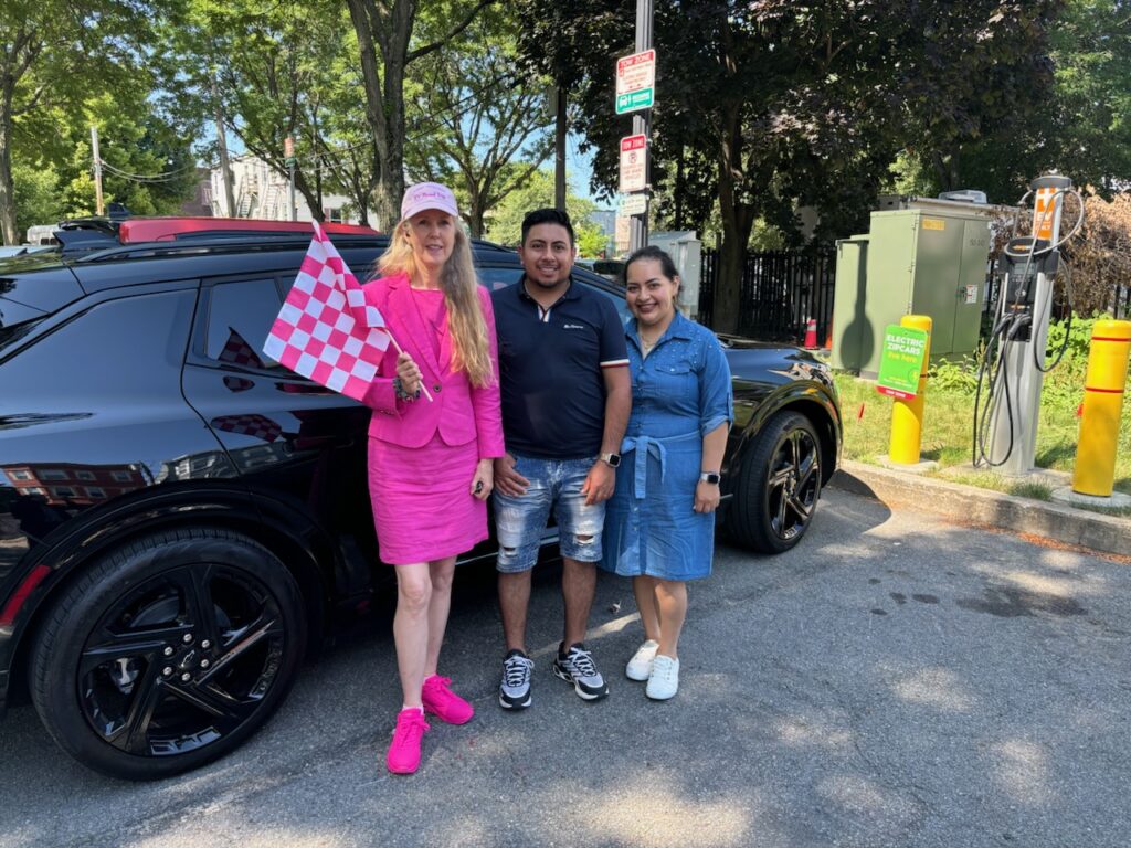 Daphne Dixon poses with her Chevrolet Equinox EV during her cross country EV Road Trip in July 2024.