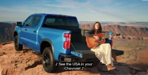 Brooke Lee sings 'See the USA in your Chevrolet' from the tailgate of a new 2026 Chevy Silverado at the top of Castle Rock!