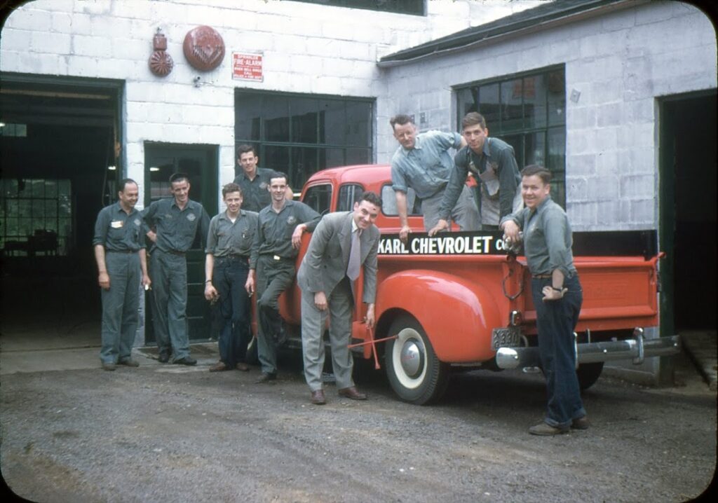 Leo E. Karl Jr., center, with the Karl Chevrolet service team, early 1950s — the same years he was serving his country and building a business his father had started in 1927.